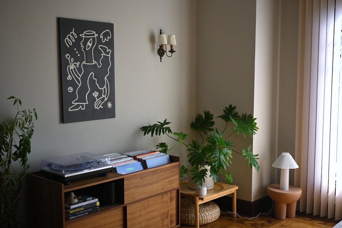 Cozy room with art and plants.